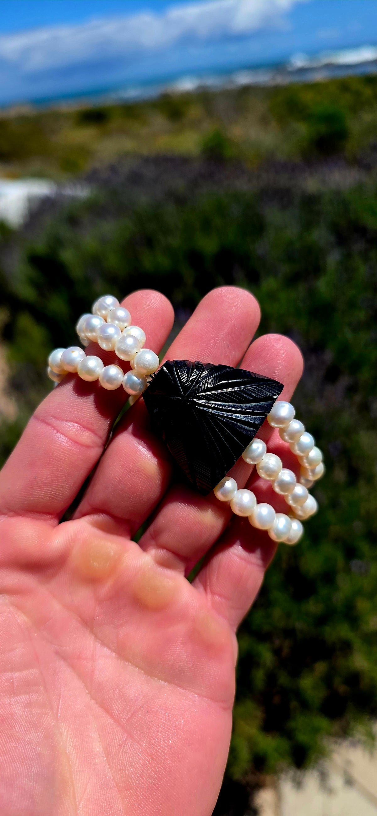 A fabulous marriage of Victorian history and contemporary elegance, bringing together an antique Whitby jet mourning jewellery panel and three beautiful strands of lustrous freshwater cultured pearls.