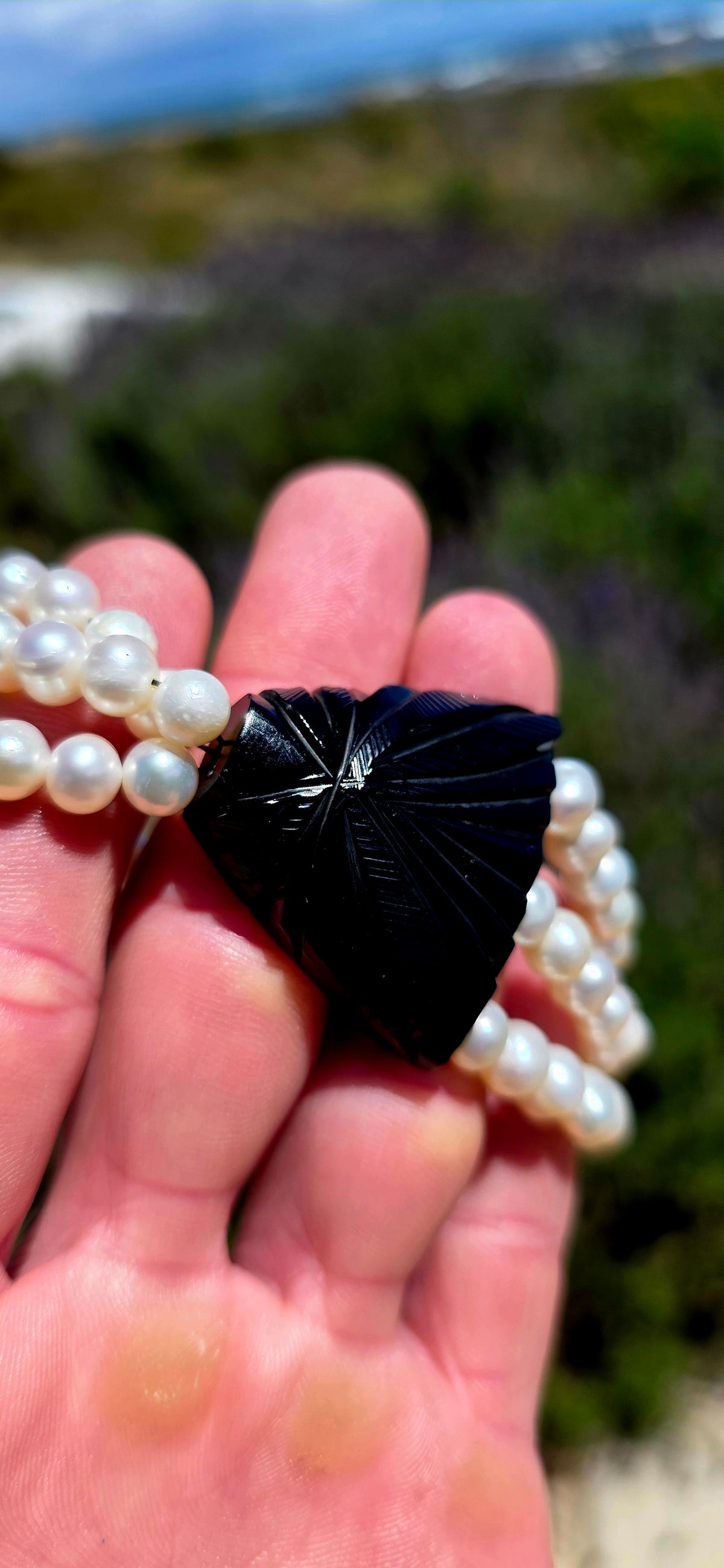 A fabulous marriage of Victorian history and contemporary elegance, bringing together an antique Whitby jet mourning jewellery panel and three beautiful strands of lustrous freshwater cultured pearls.