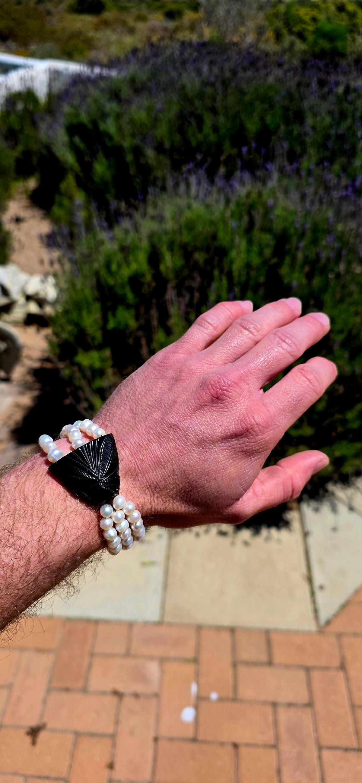 A fabulous marriage of Victorian history and contemporary elegance, bringing together an antique Whitby jet mourning jewellery panel and three beautiful strands of lustrous freshwater cultured pearls.