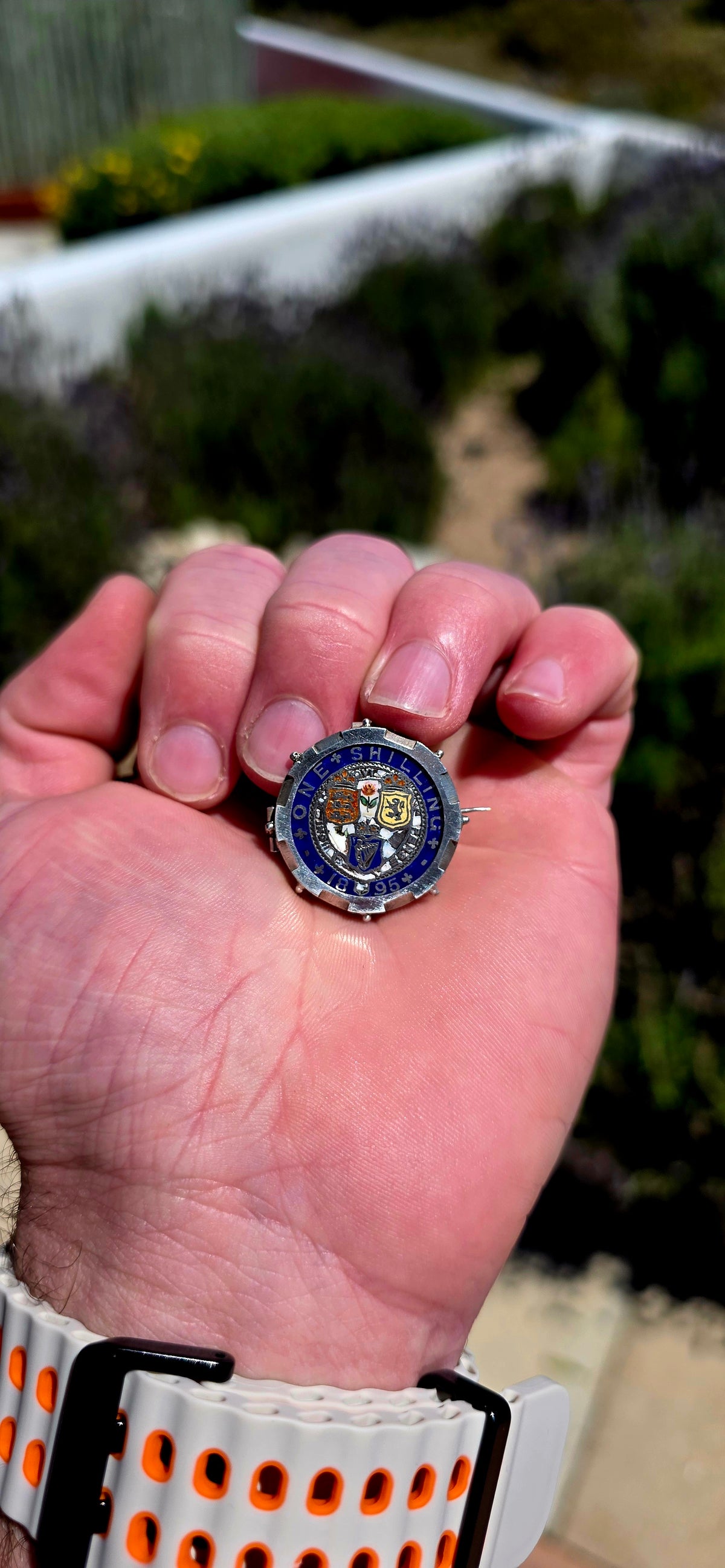A beautiful antique sweetheart brooch featuring a genuine 1895 British sterling silver One Shilling coin, wonderfully decorated with colourful enamel!