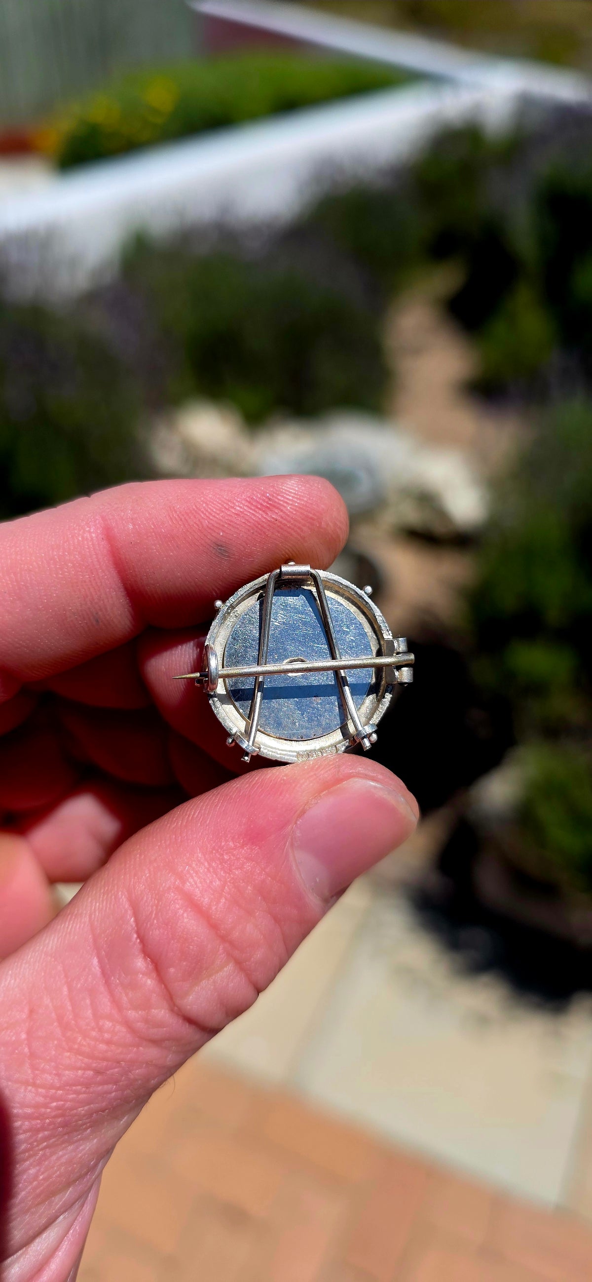 A lovely antique sterling silver brooch featuring a circular St Christopher devotional medallion, beautifully detailed with a raised depiction of the beloved patron saint of travellers.