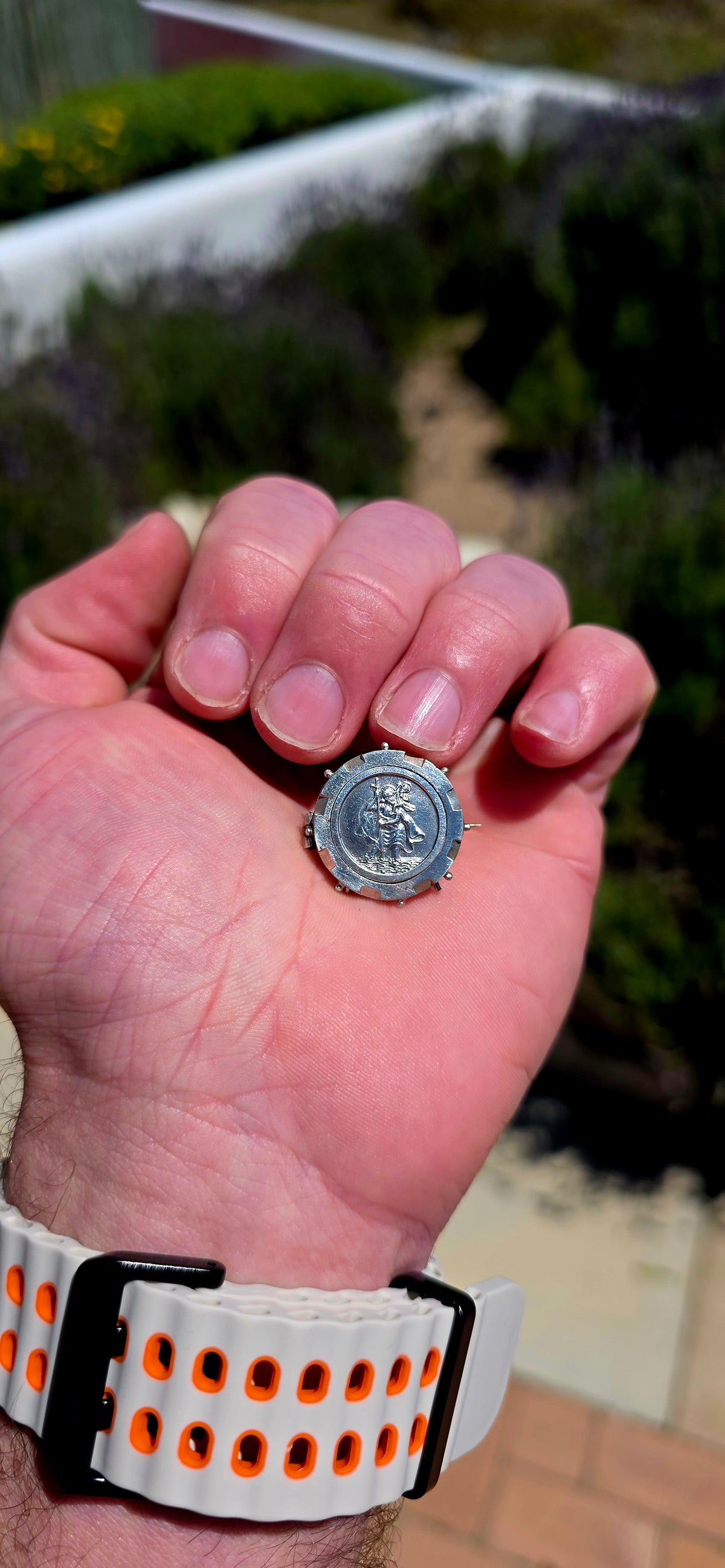A lovely antique sterling silver brooch featuring a circular St Christopher devotional medallion, beautifully detailed with a raised depiction of the beloved patron saint of travellers.