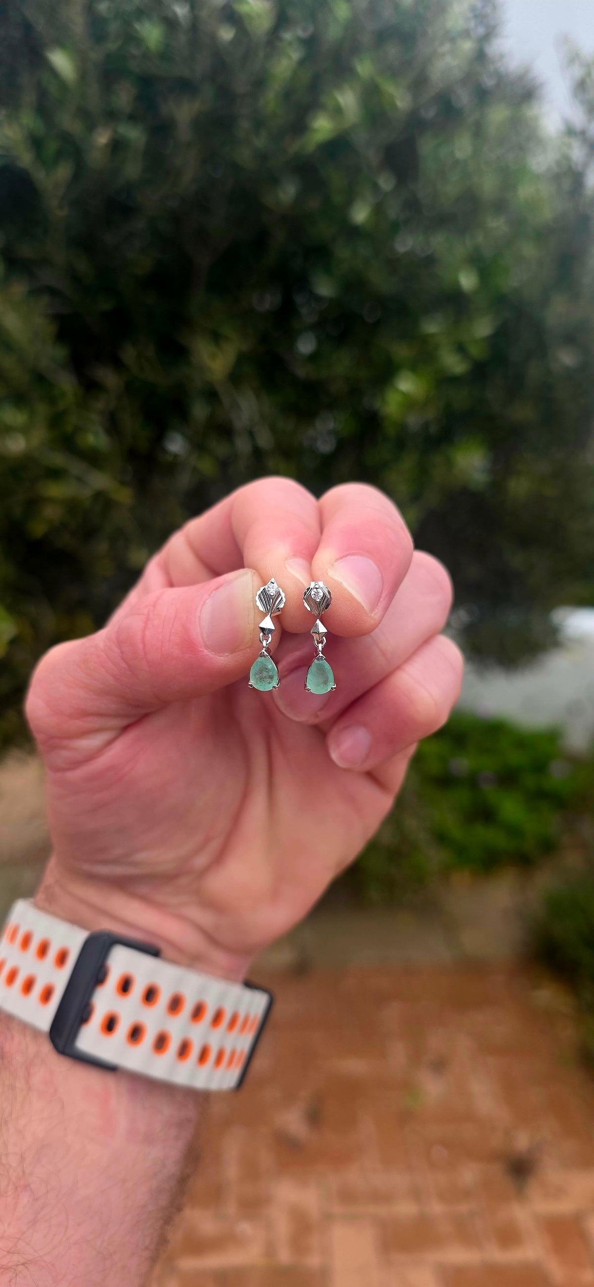 A beautiful pair of sterling silver drop earrings combining the enchanting green of emeralds with the delicate sparkle of white topaz!