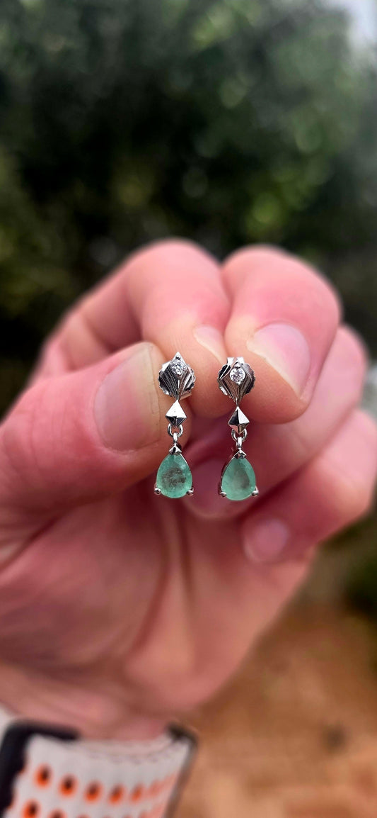 A beautiful pair of sterling silver drop earrings combining the enchanting green of emeralds with the delicate sparkle of white topaz!