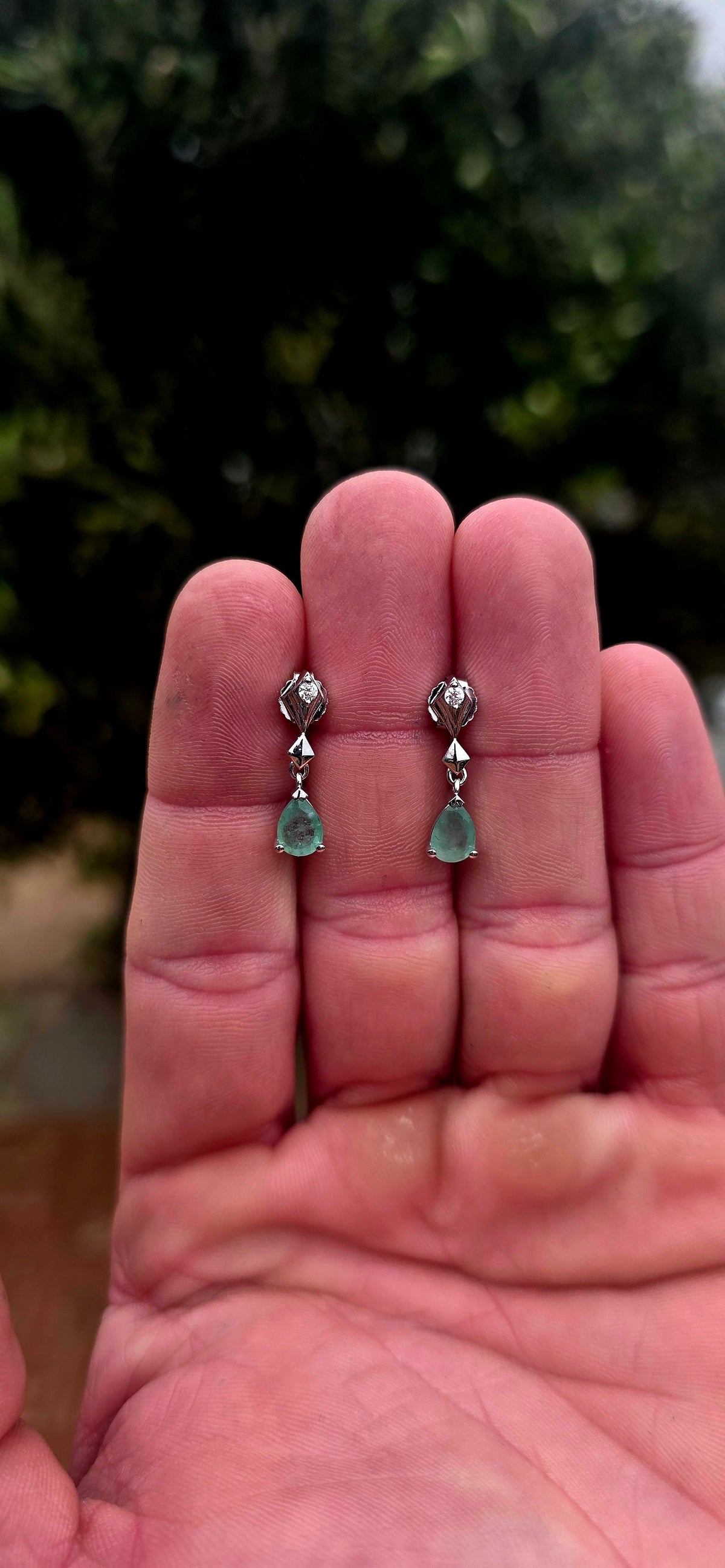 A beautiful pair of sterling silver drop earrings combining the enchanting green of emeralds with the delicate sparkle of white topaz!