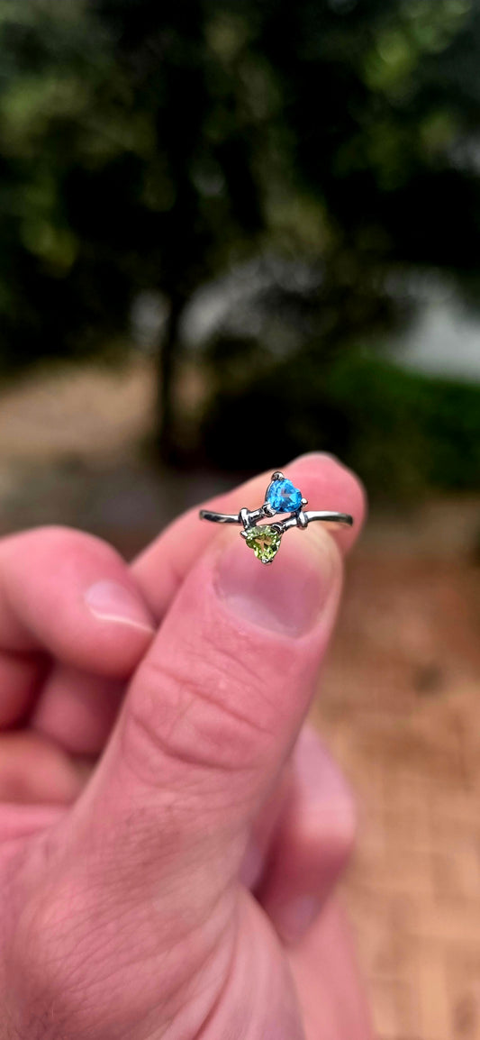 A beautifully dainty and feminine sterling silver Toi et Moi bypass ring, featuring two gorgeous fancy heart-cut gemstones nestled together in a wonderfully romantic design!