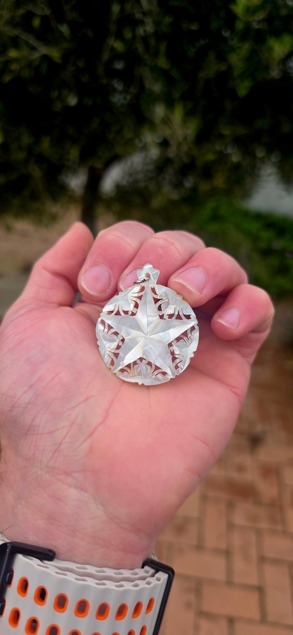 A beautiful vintage hand-carved mother-of-pearl pendant, featuring a magnificent five-pointed star surrounded by delicate openwork detailing!