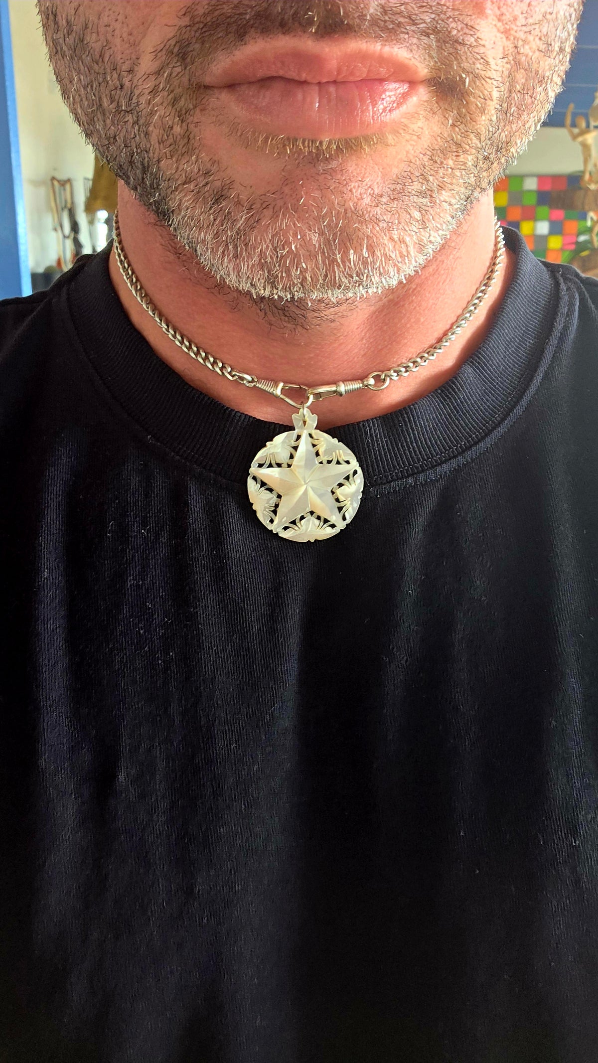 A beautiful vintage hand-carved mother-of-pearl pendant, featuring a magnificent five-pointed star surrounded by delicate openwork detailing!