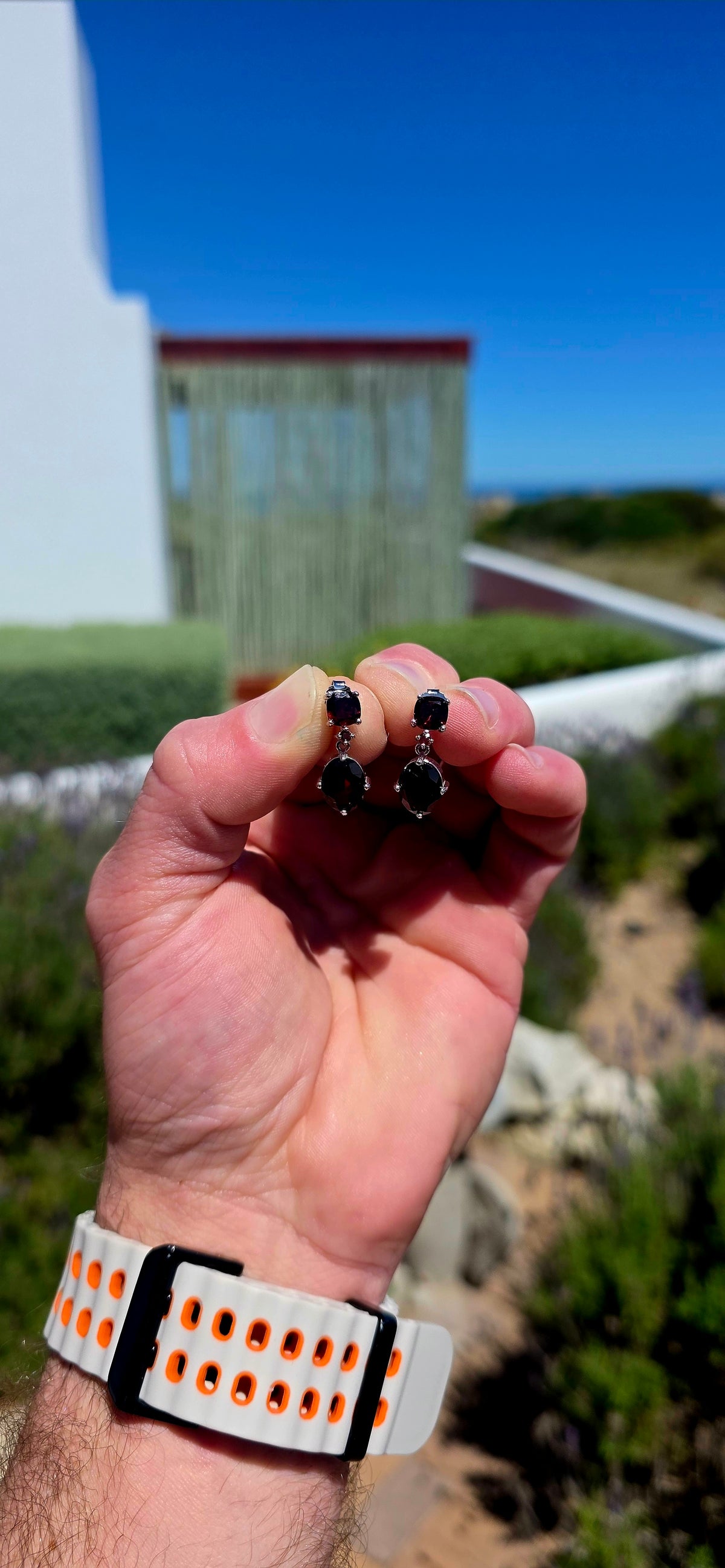 A beautifully elegant pair of sterling silver and garnet drop earrings, featuring the most delicious deep wine-red garnets.