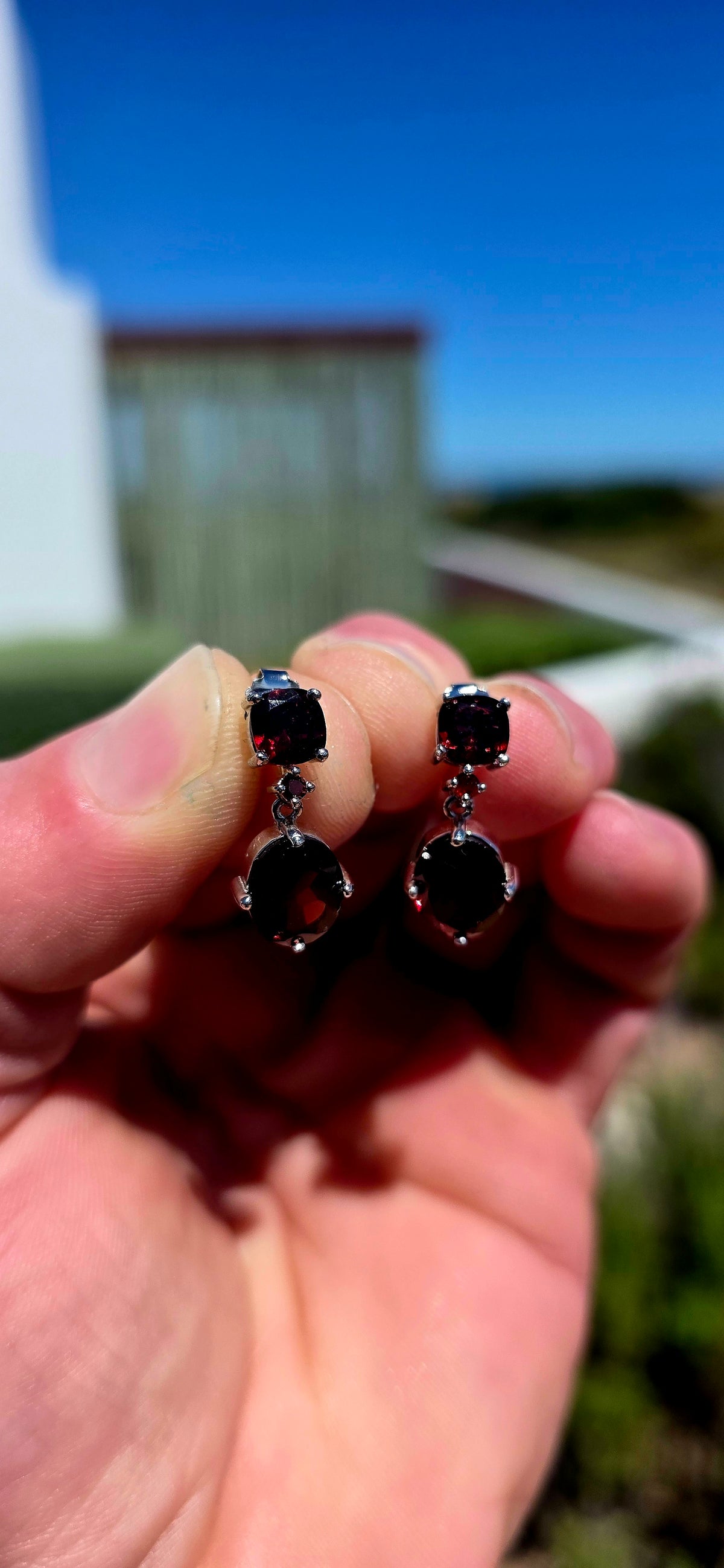 A beautifully elegant pair of sterling silver and garnet drop earrings, featuring the most delicious deep wine-red garnets.
