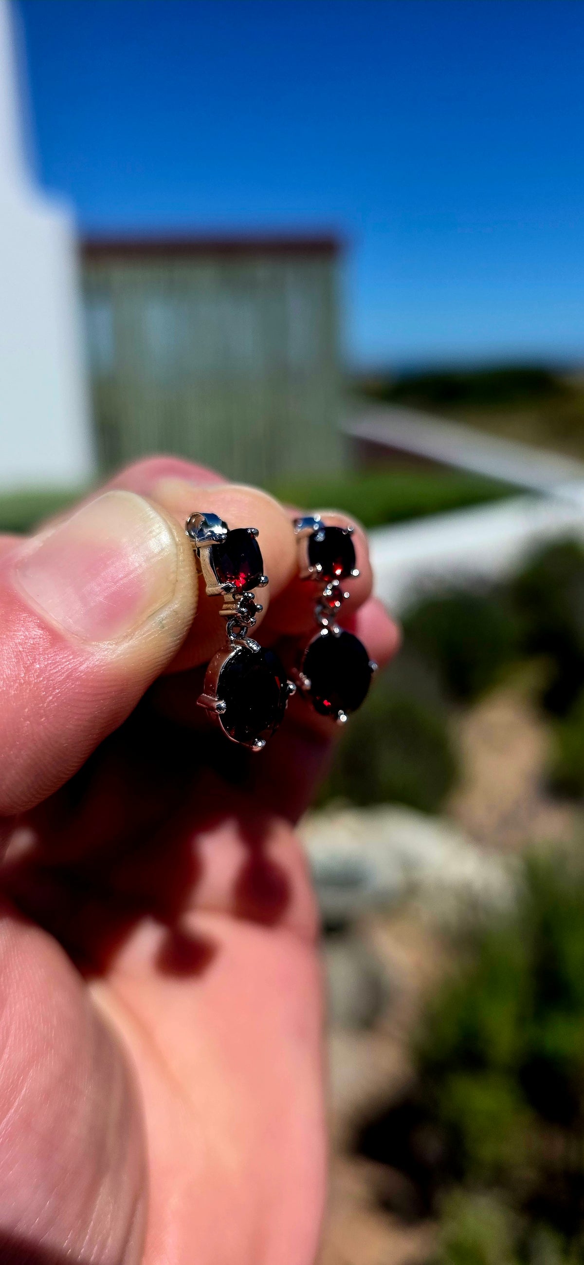 A beautifully elegant pair of sterling silver and garnet drop earrings, featuring the most delicious deep wine-red garnets.