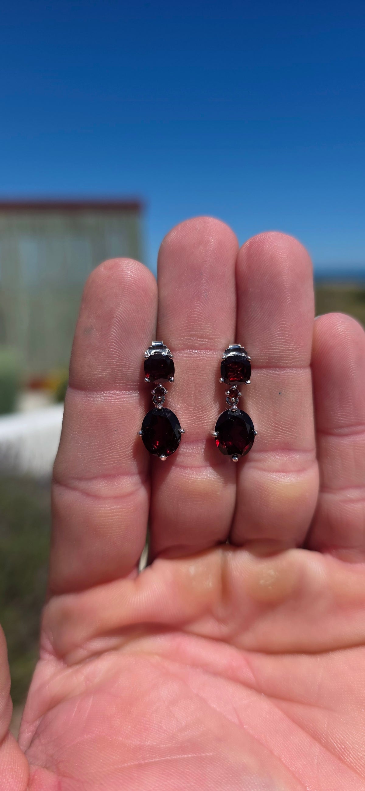 A beautifully elegant pair of sterling silver and garnet drop earrings, featuring the most delicious deep wine-red garnets.