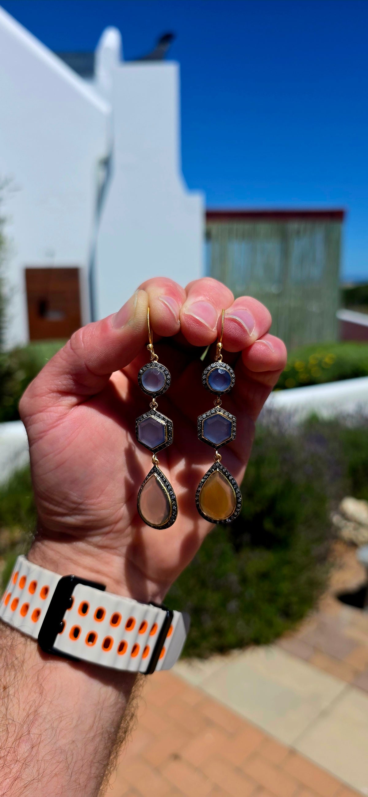 A magical pair of sterling silver drop earrings, beautifully finished in rich satin yellow gold plating and adorned with an exquisite combination of softly glowing chalcedony gemstones and sparkling cubic zirconia accents.