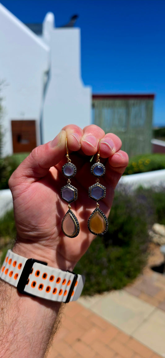 A magical pair of sterling silver drop earrings, beautifully finished in rich satin yellow gold plating and adorned with an exquisite combination of softly glowing chalcedony gemstones and sparkling cubic zirconia accents.