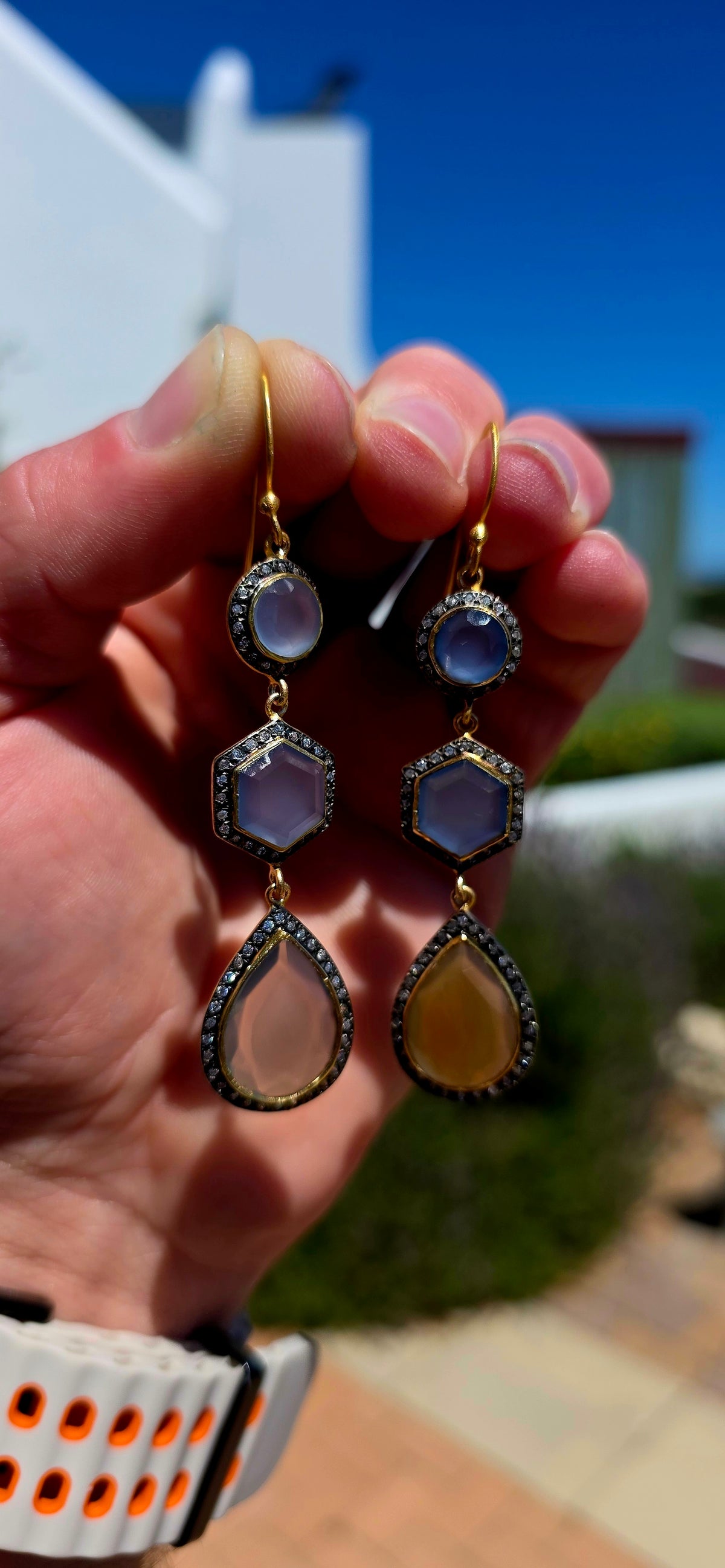 A magical pair of sterling silver drop earrings, beautifully finished in rich satin yellow gold plating and adorned with an exquisite combination of softly glowing chalcedony gemstones and sparkling cubic zirconia accents.