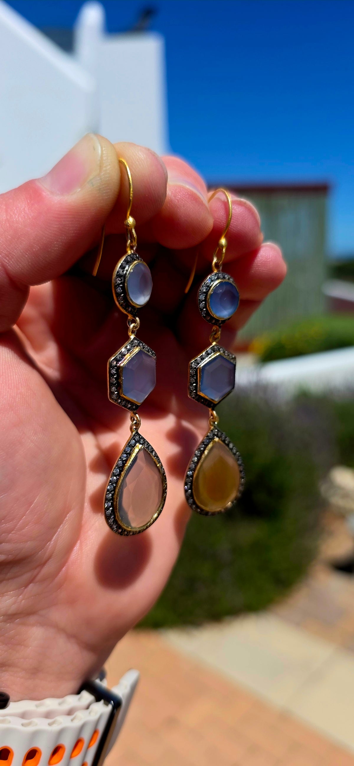 A magical pair of sterling silver drop earrings, beautifully finished in rich satin yellow gold plating and adorned with an exquisite combination of softly glowing chalcedony gemstones and sparkling cubic zirconia accents.