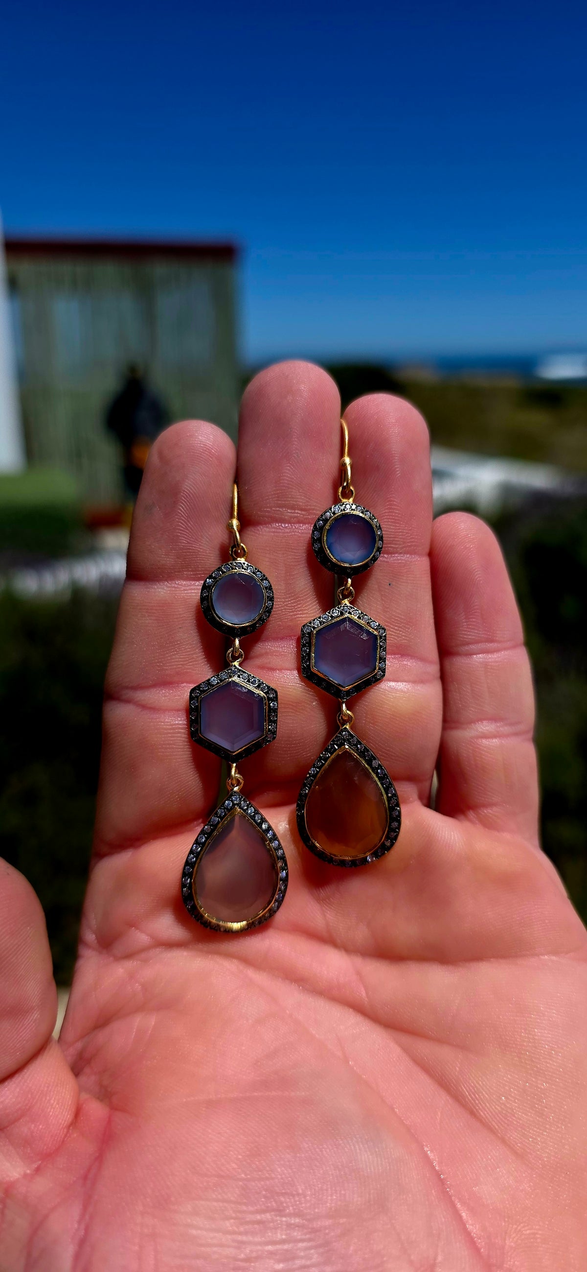 A magical pair of sterling silver drop earrings, beautifully finished in rich satin yellow gold plating and adorned with an exquisite combination of softly glowing chalcedony gemstones and sparkling cubic zirconia accents.