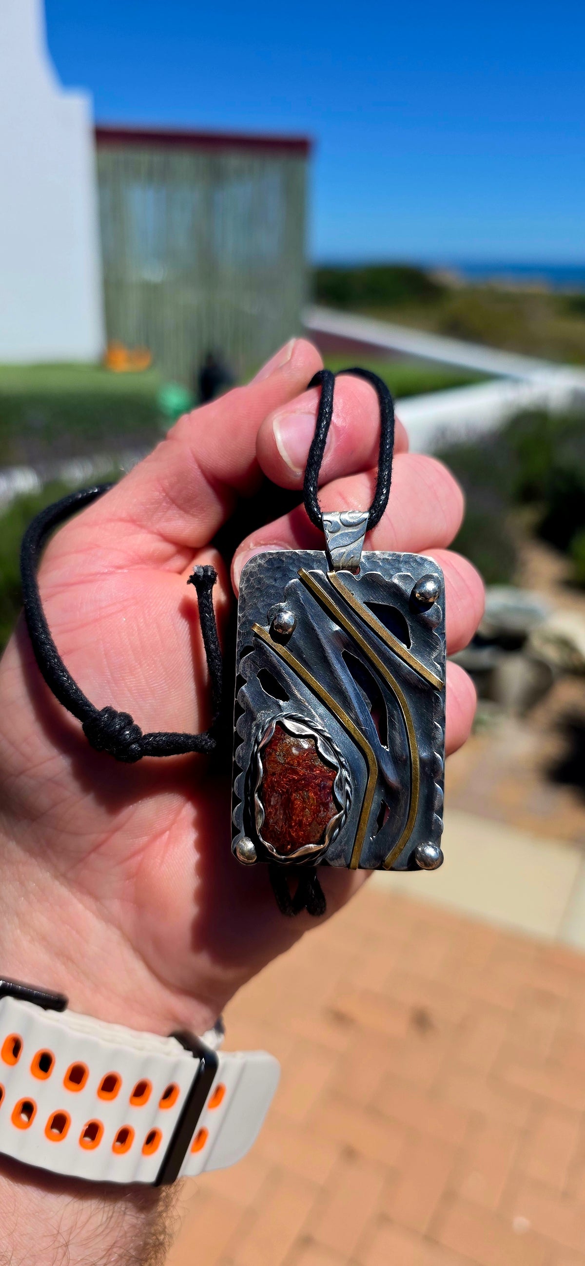 A spectacular oversized, handcrafted sterling silver statement pendant combining architectural design, contrasting metals and the beautiful earthy character of natural agate.