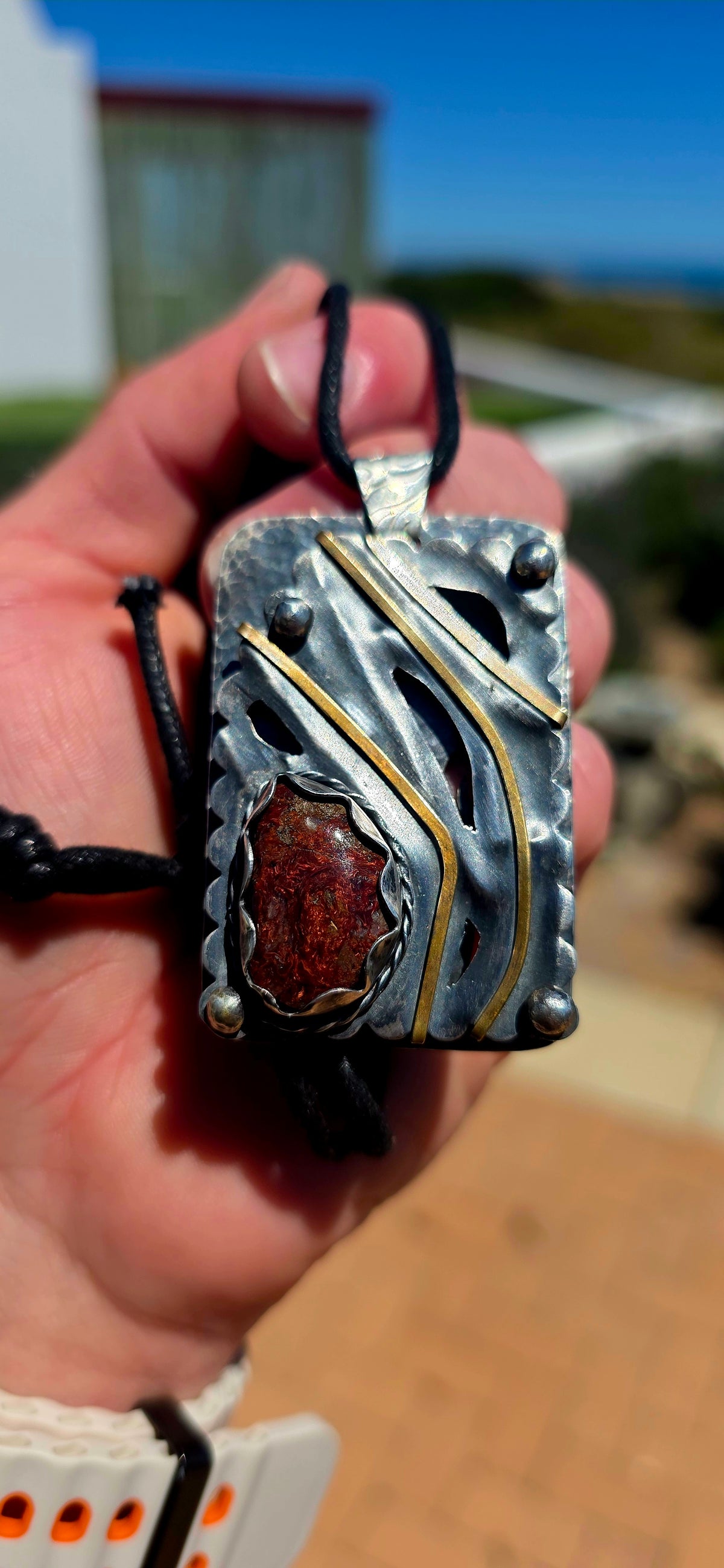 A spectacular oversized, handcrafted sterling silver statement pendant combining architectural design, contrasting metals and the beautiful earthy character of natural agate.
