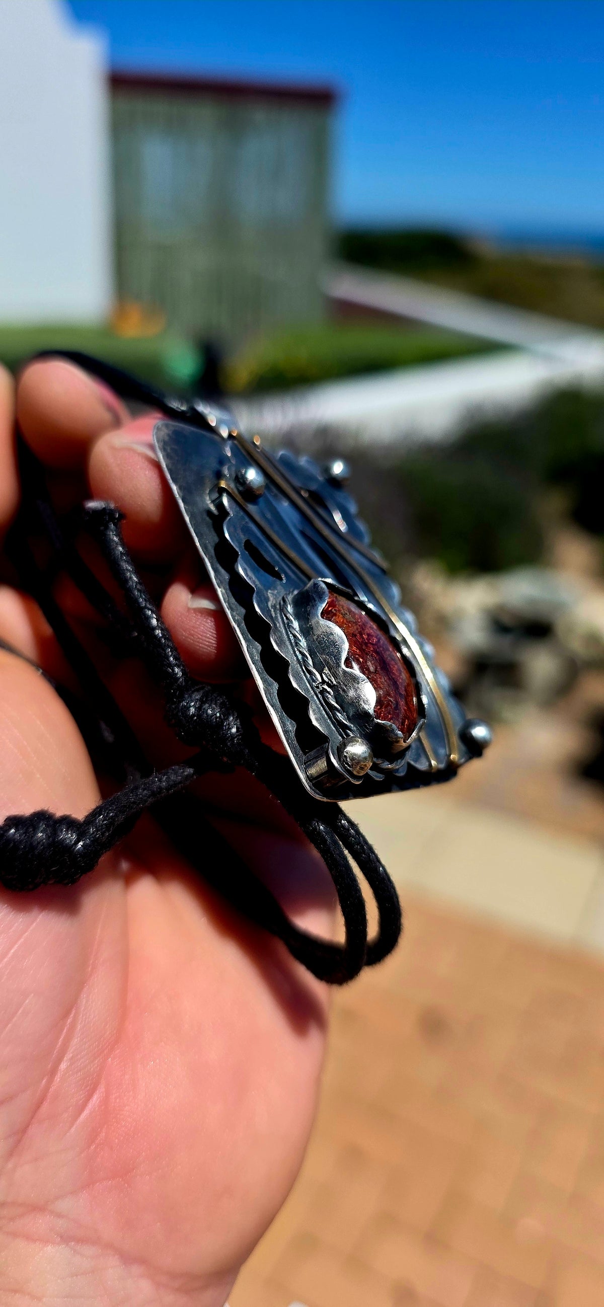 A spectacular oversized, handcrafted sterling silver statement pendant combining architectural design, contrasting metals and the beautiful earthy character of natural agate.