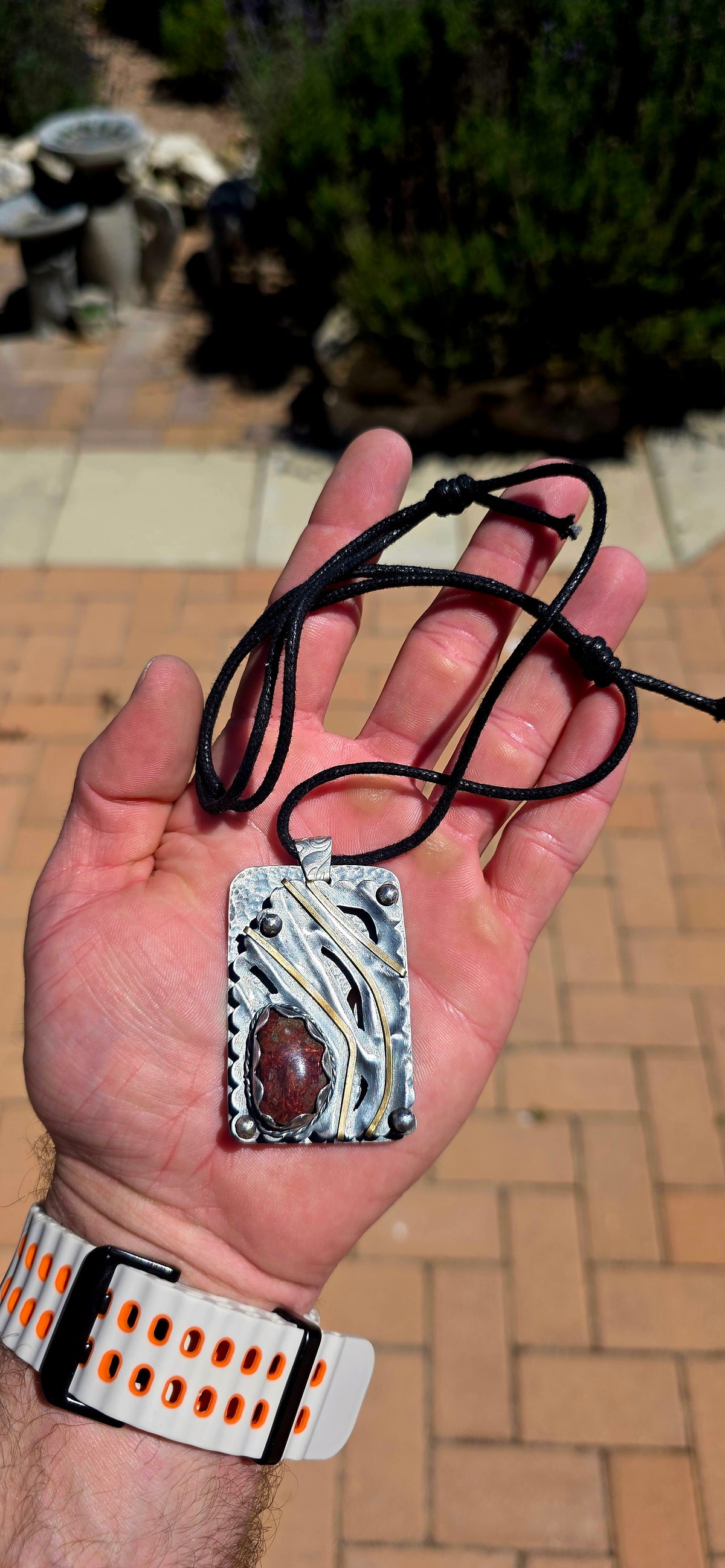 A spectacular oversized, handcrafted sterling silver statement pendant combining architectural design, contrasting metals and the beautiful earthy character of natural agate.