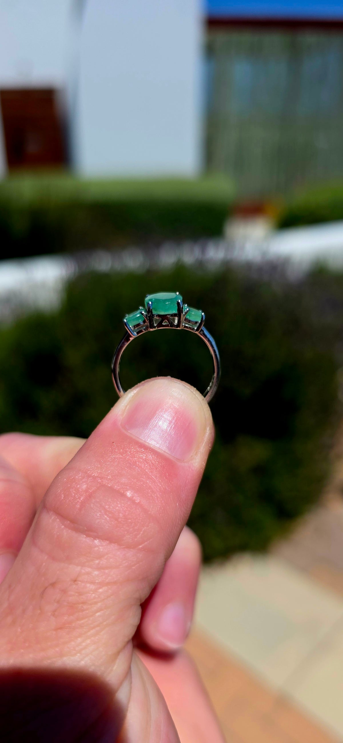 A wonderfully elegant sterling silver and emerald trilogy ring, featuring three gorgeous round-cut emerald gemstones in the most enchanting shades of green!