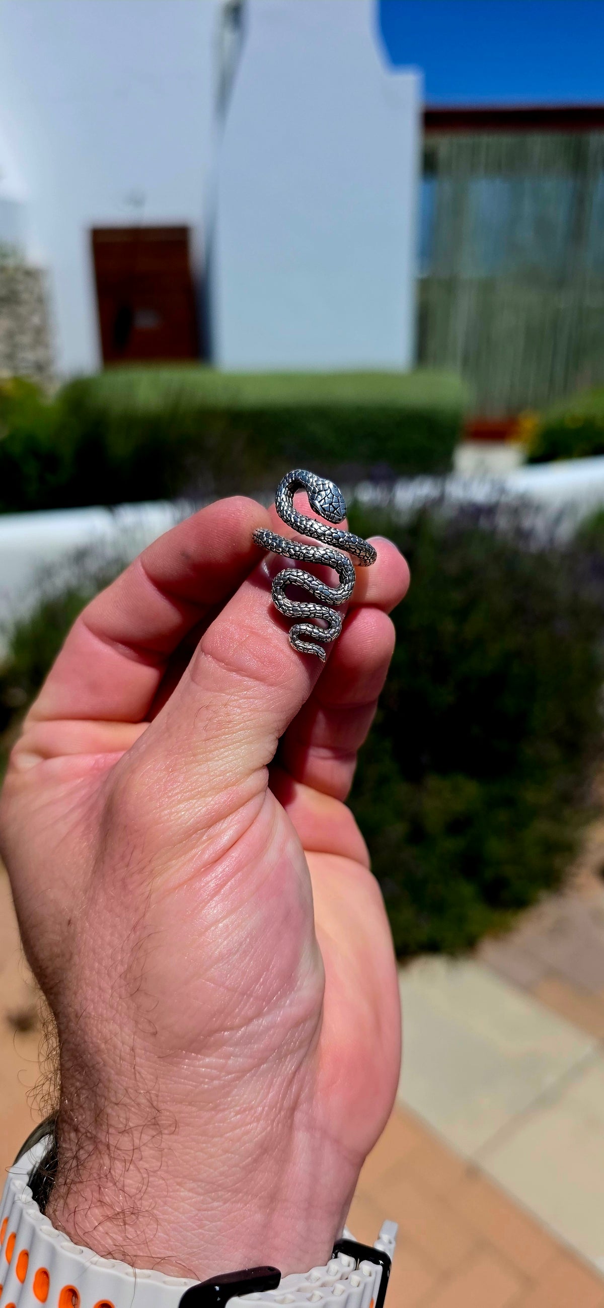 A striking, chunky unisex sterling silver serpent ring, featuring an incredibly detailed snake winding its way around the finger in a dramatic, sculptural design!