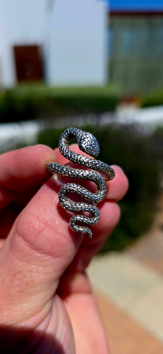 A striking, chunky unisex sterling silver serpent ring, featuring an incredibly detailed snake winding its way around the finger in a dramatic, sculptural design!