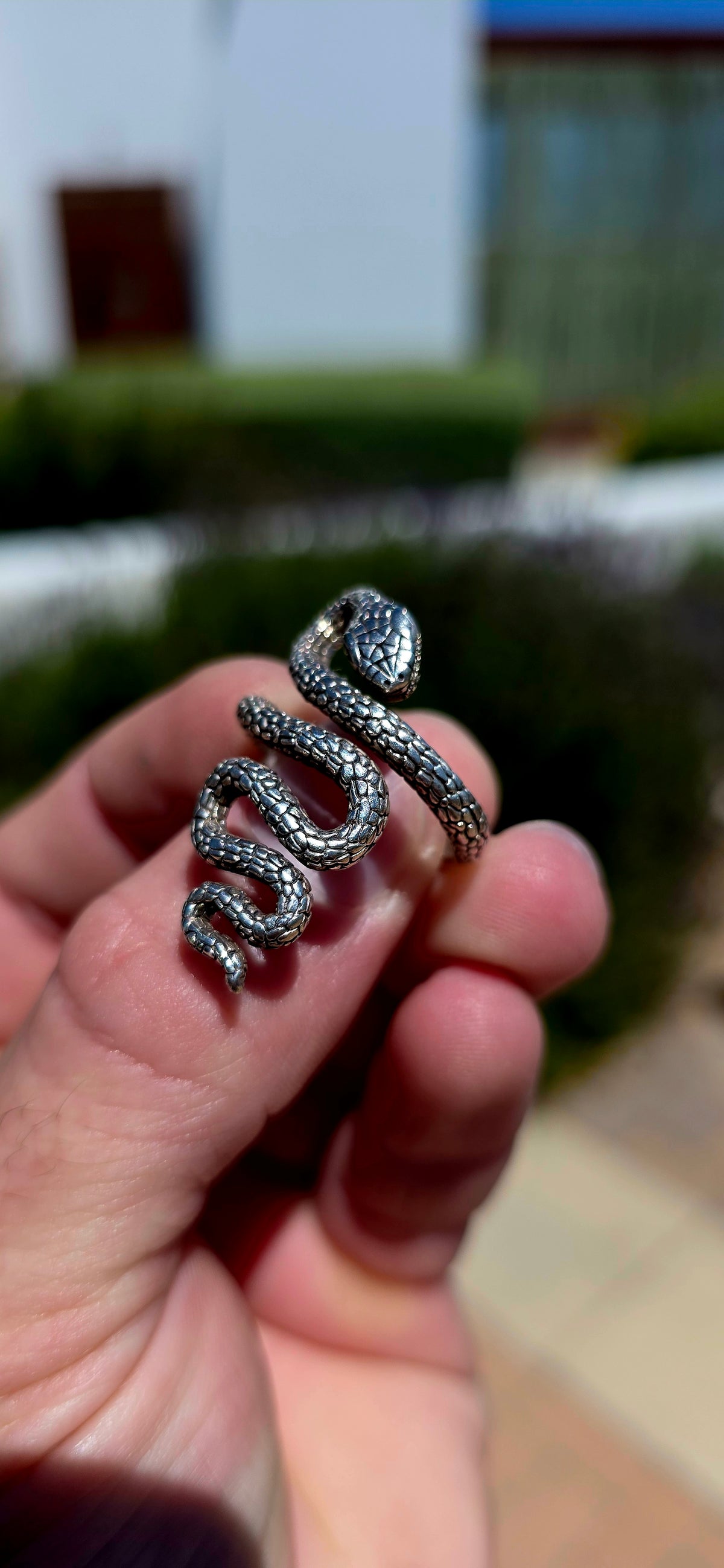 A striking, chunky unisex sterling silver serpent ring, featuring an incredibly detailed snake winding its way around the finger in a dramatic, sculptural design!