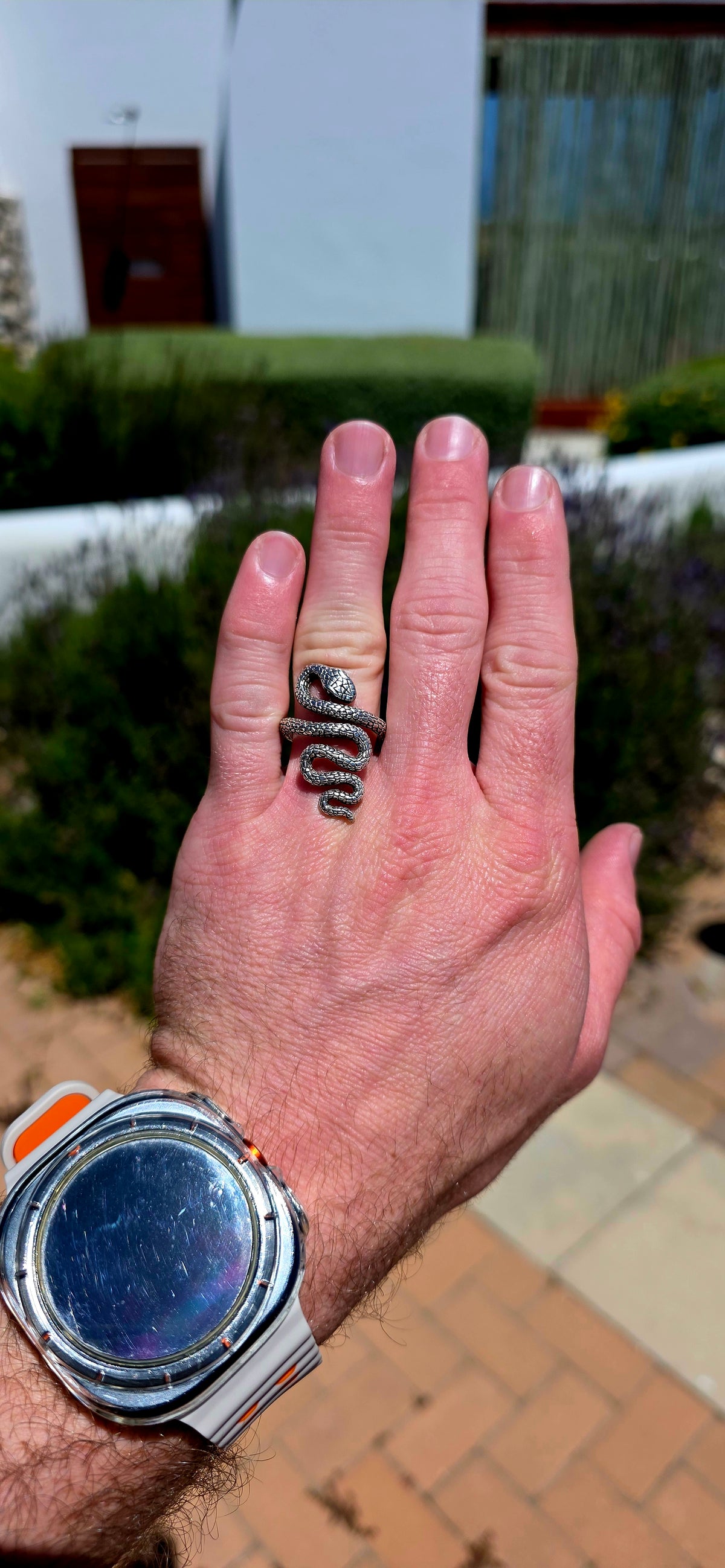 A striking, chunky unisex sterling silver serpent ring, featuring an incredibly detailed snake winding its way around the finger in a dramatic, sculptural design!