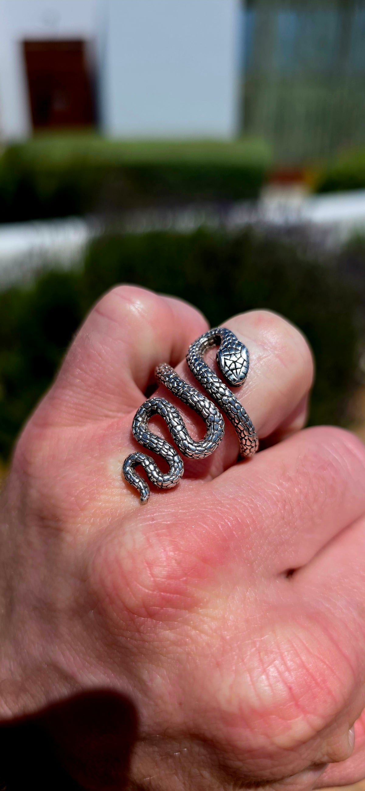 A striking, chunky unisex sterling silver serpent ring, featuring an incredibly detailed snake winding its way around the finger in a dramatic, sculptural design!