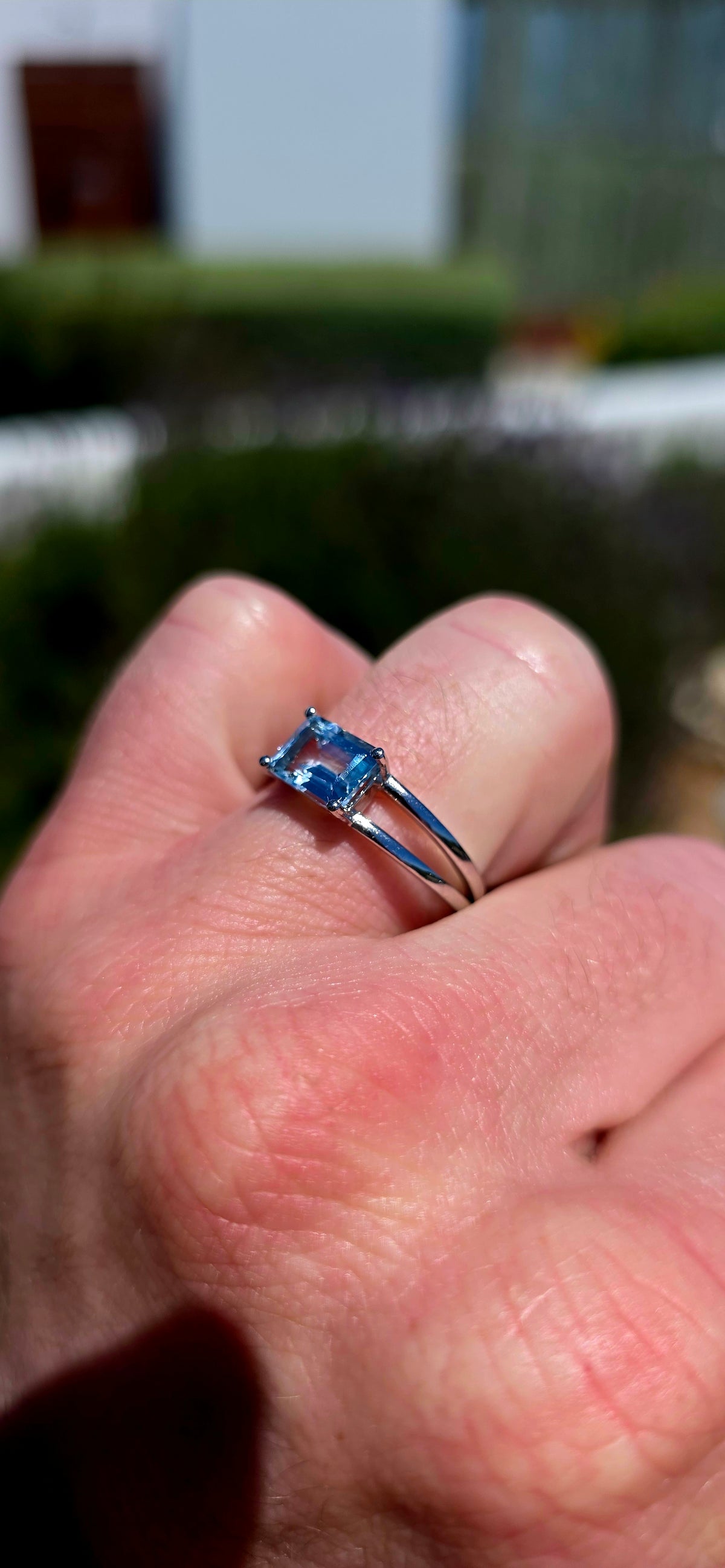 A wonderfully elegant sterling silver solitaire ring featuring a gorgeous emerald-cut sky blue topaz, beautifully showcased in a delicate, contemporary setting!
