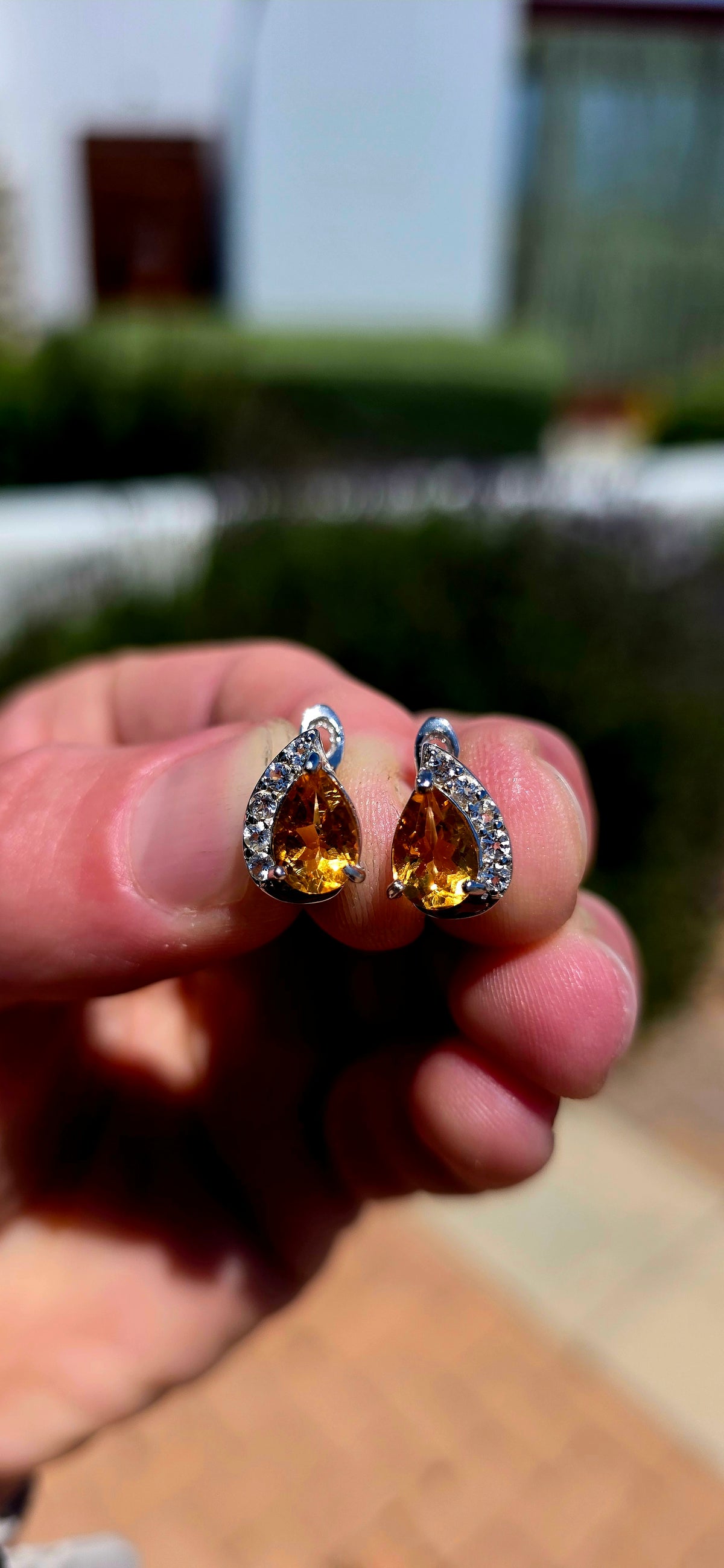 A wonderfully elegant pair of sterling silver earrings featuring the most beautiful golden-yellow citrine gemstones, surrounded by just the right amount of sparkle!