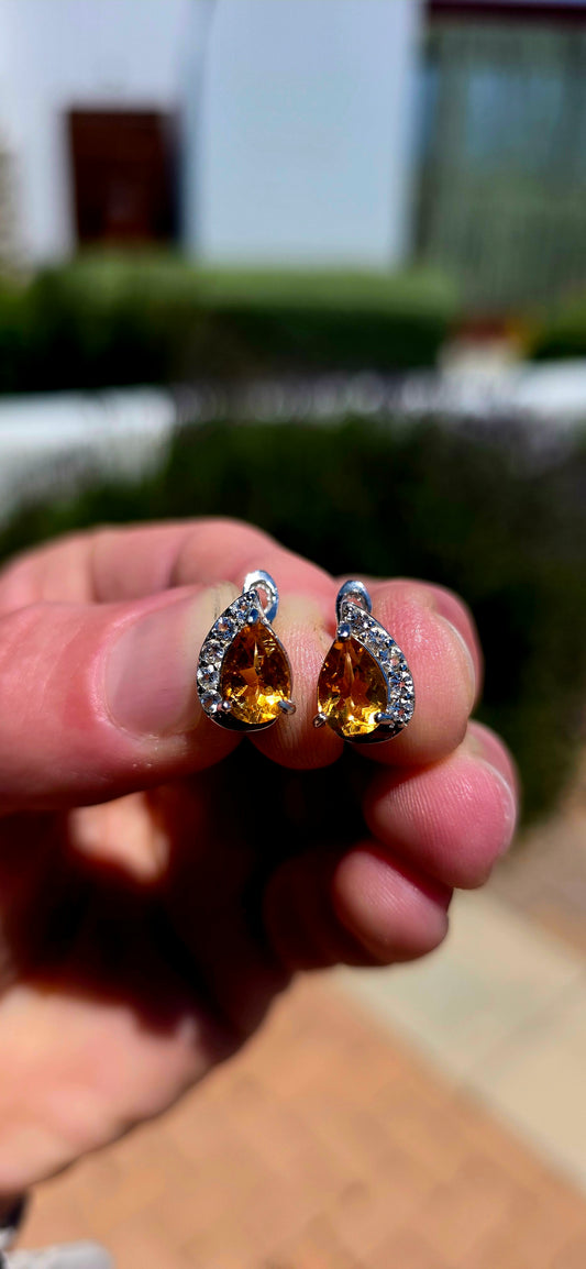 A wonderfully elegant pair of sterling silver earrings featuring the most beautiful golden-yellow citrine gemstones, surrounded by just the right amount of sparkle!