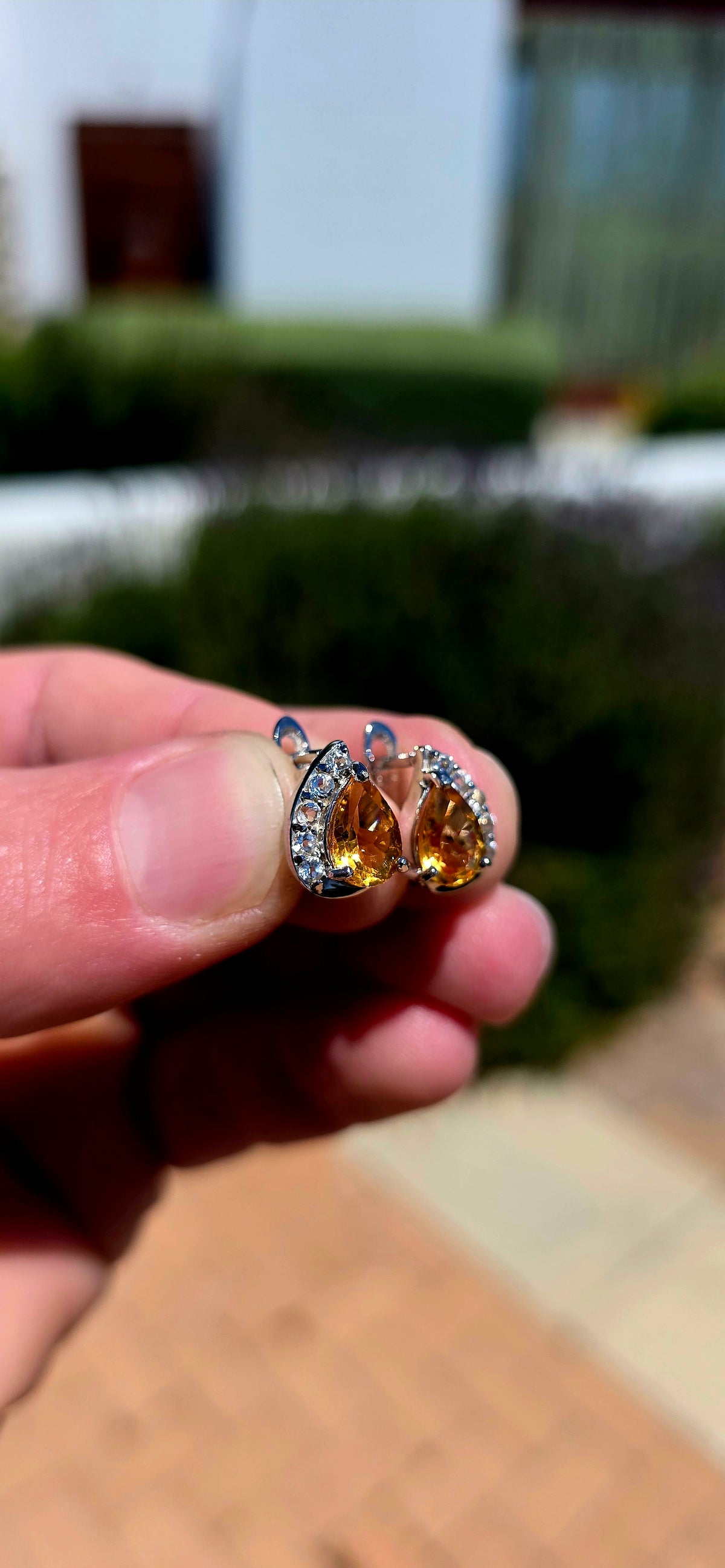 A wonderfully elegant pair of sterling silver earrings featuring the most beautiful golden-yellow citrine gemstones, surrounded by just the right amount of sparkle!