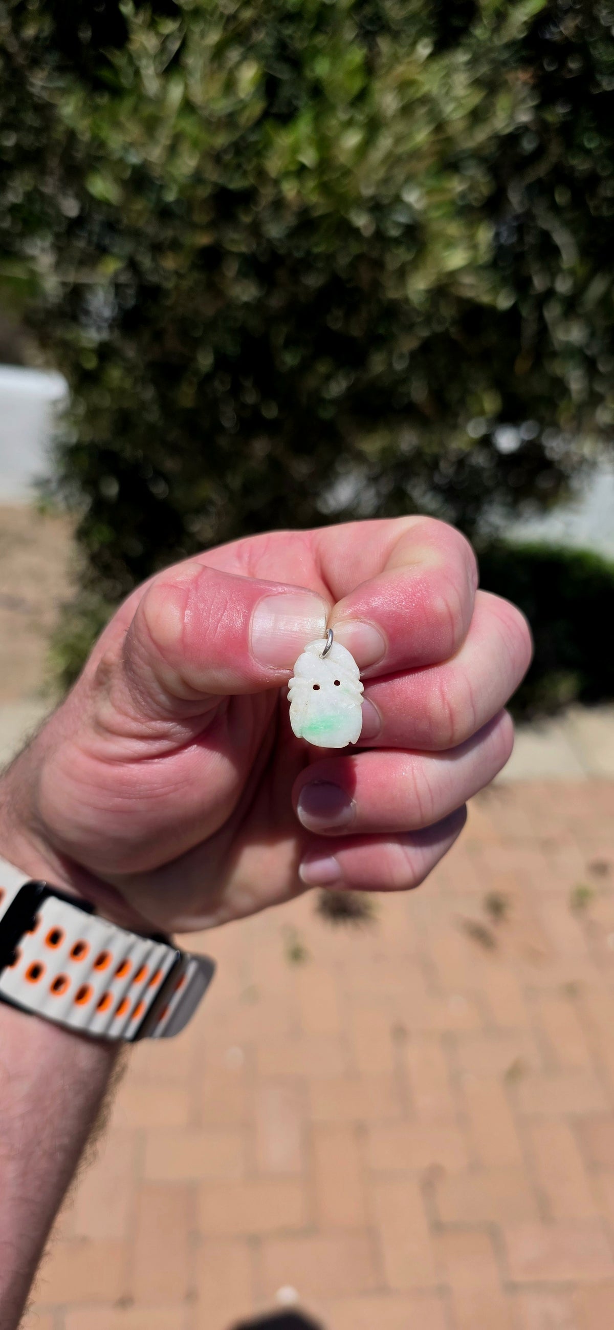 A delightful antique Chinese jade pendant, intricately hand-carved into a miniature fruit-inspired design, with the loveliest soft white colouring and beautiful natural splashes of vibrant apple green!
