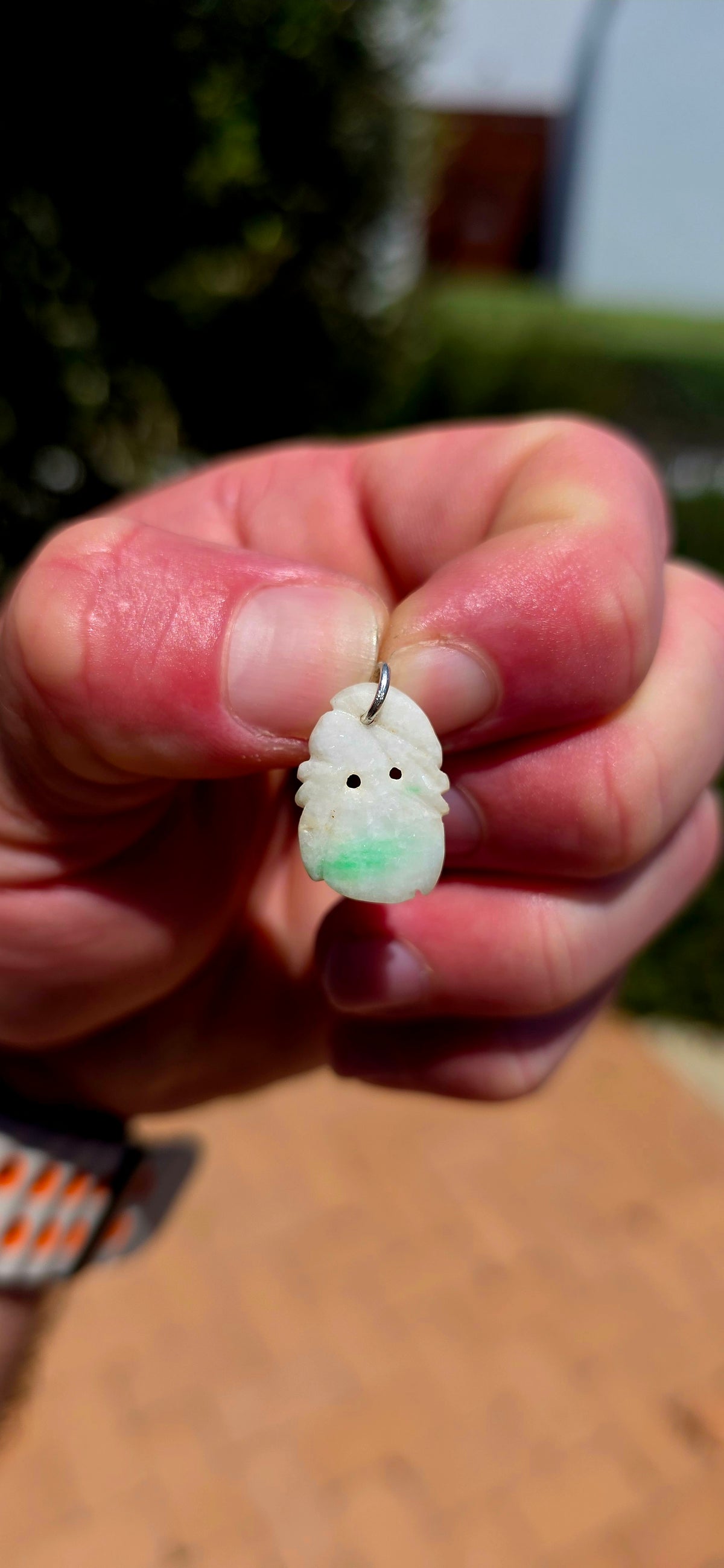 A delightful antique Chinese jade pendant, intricately hand-carved into a miniature fruit-inspired design, with the loveliest soft white colouring and beautiful natural splashes of vibrant apple green!