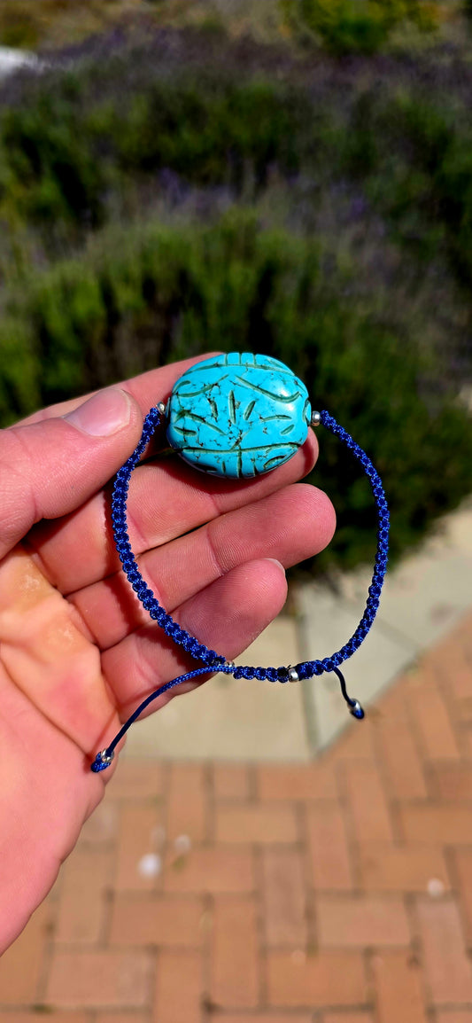 A wonderfully striking artisan-made bracelet combining vibrant colour, beautiful hand-carved detailing and a fabulous free-spirited charm!