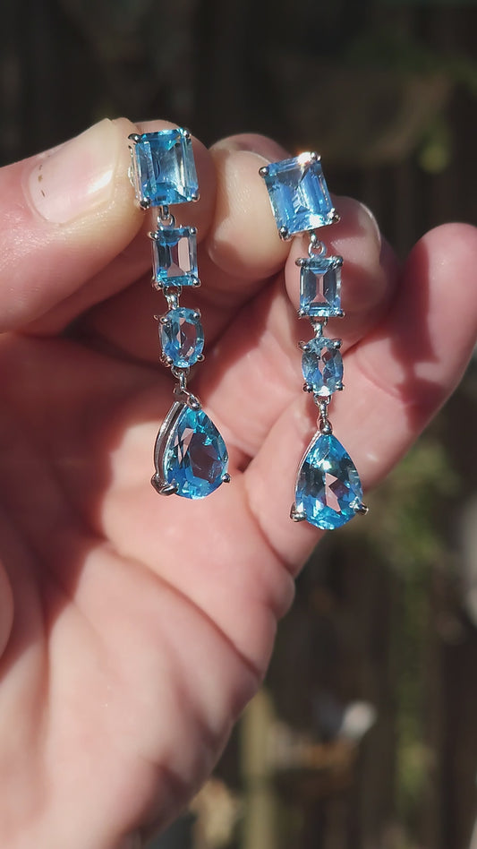 Beautiful pair of Sterling Silver and Topaz Gemstones push-in drop earrings .Each Claw set with a Pear Cut Topaz drop suspended from a line drop of 3x Rectangular and Oval Cut Topaz Gemstones.